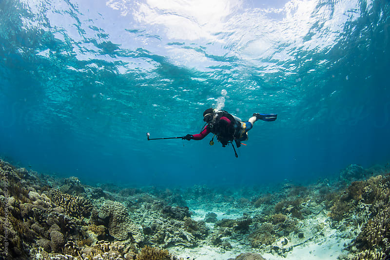 scuba diver hold selfie stick with bubble