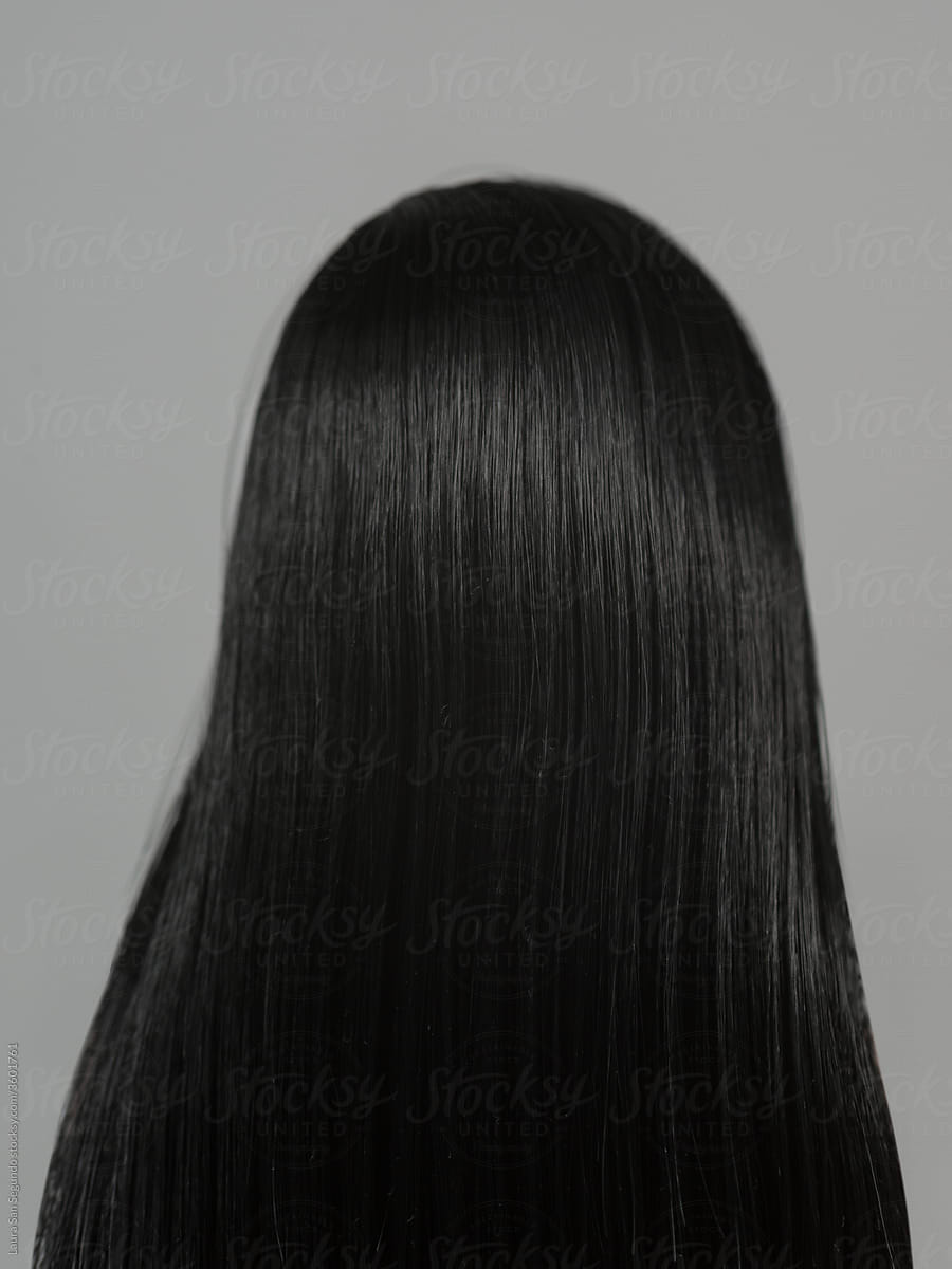 Female doll head from behind with long dark straight hair