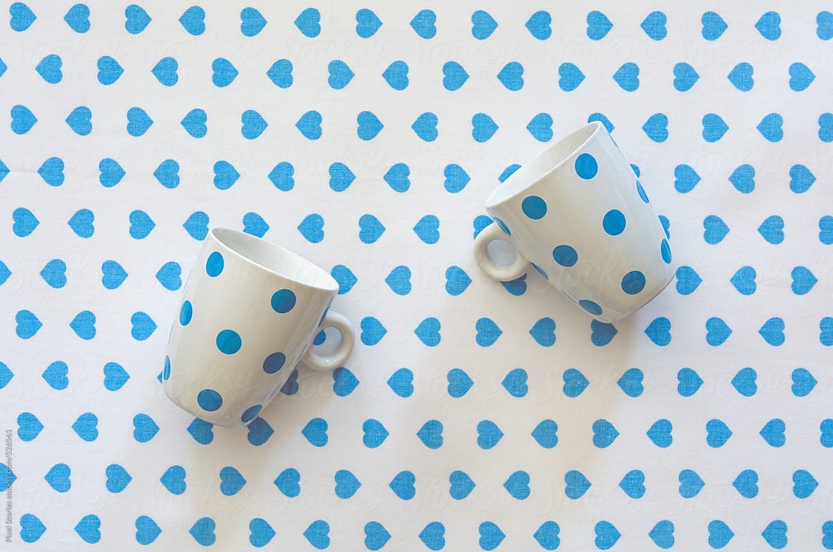 Blue-dotted cups on blue hearts cloth