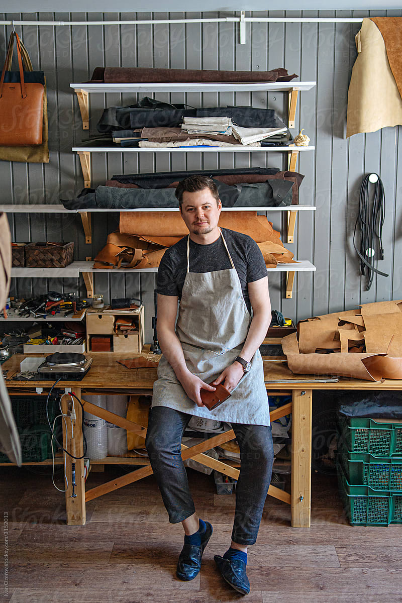 portrait of a master in his working leather workshop