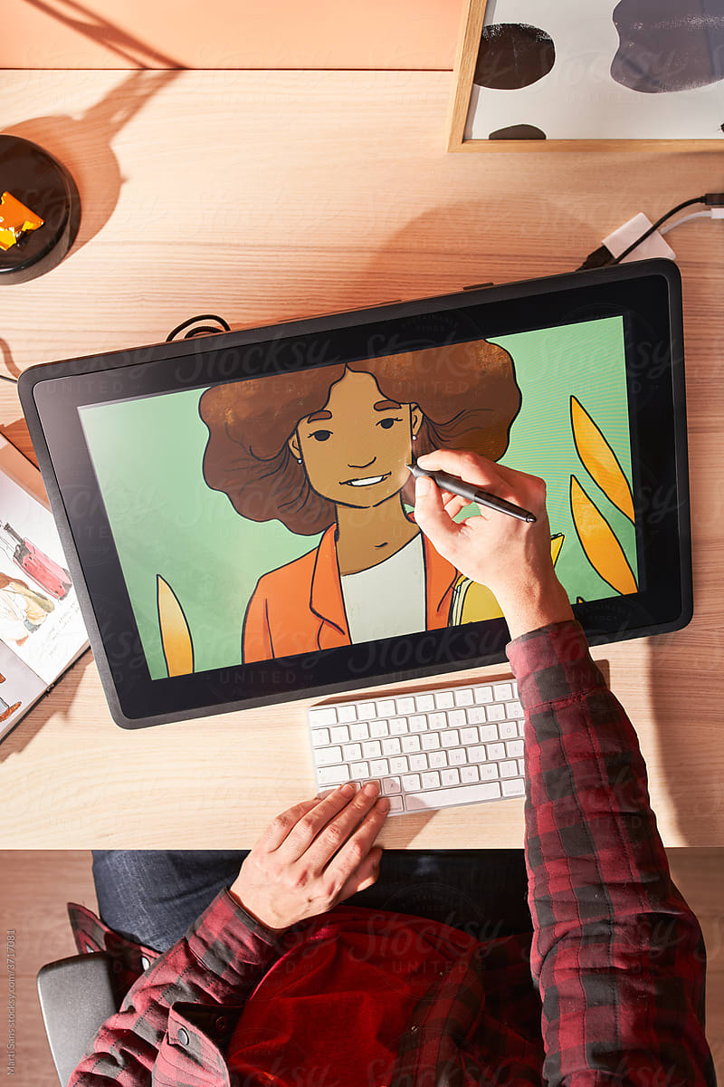 Crop anonymous artist drawing on graphic tablet at home