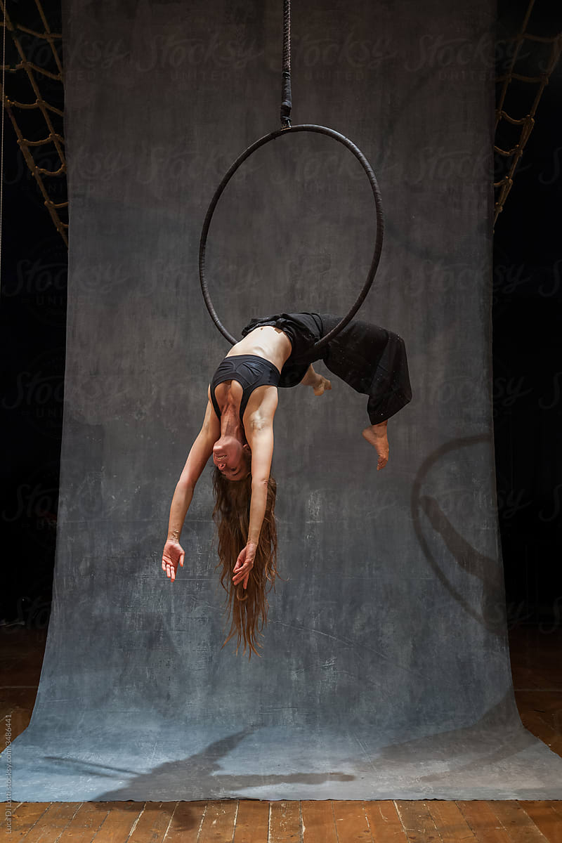 Aerial artist suspended to a Lyra or Aerial hoop 12