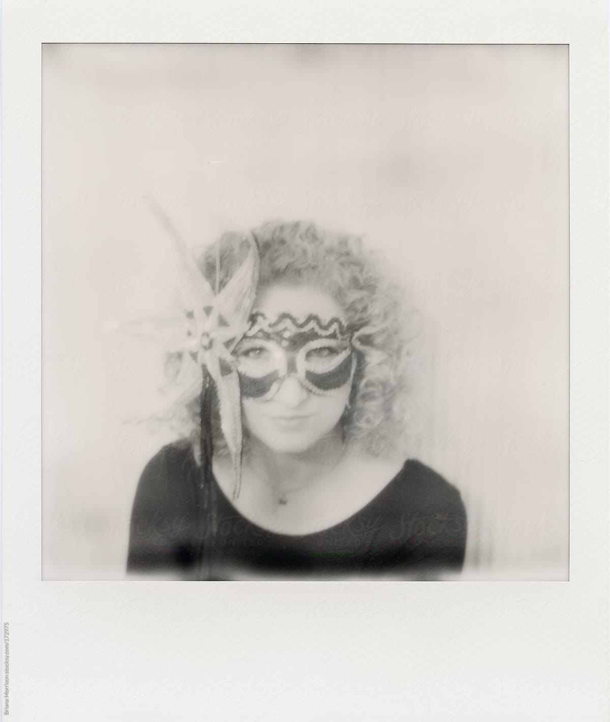 Black and White Polaroid of a Woman in a Star Mask