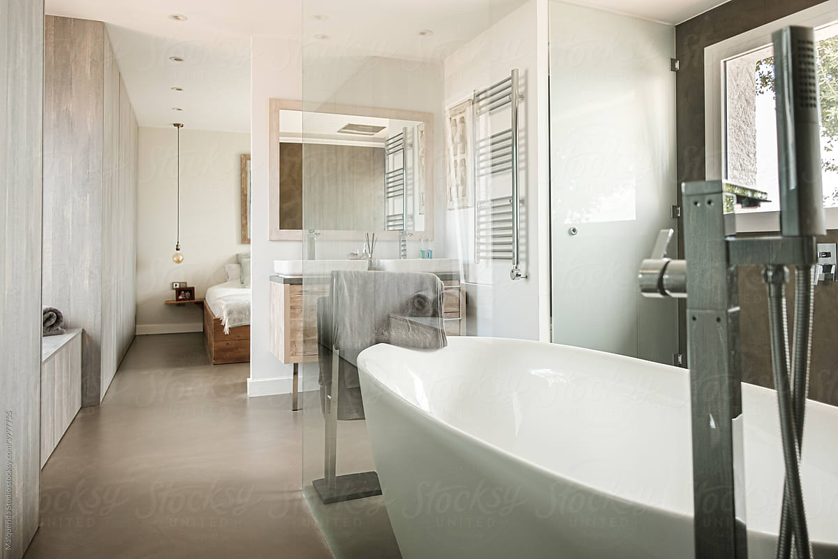 Modern bathroom with bath integrated into the bedroom