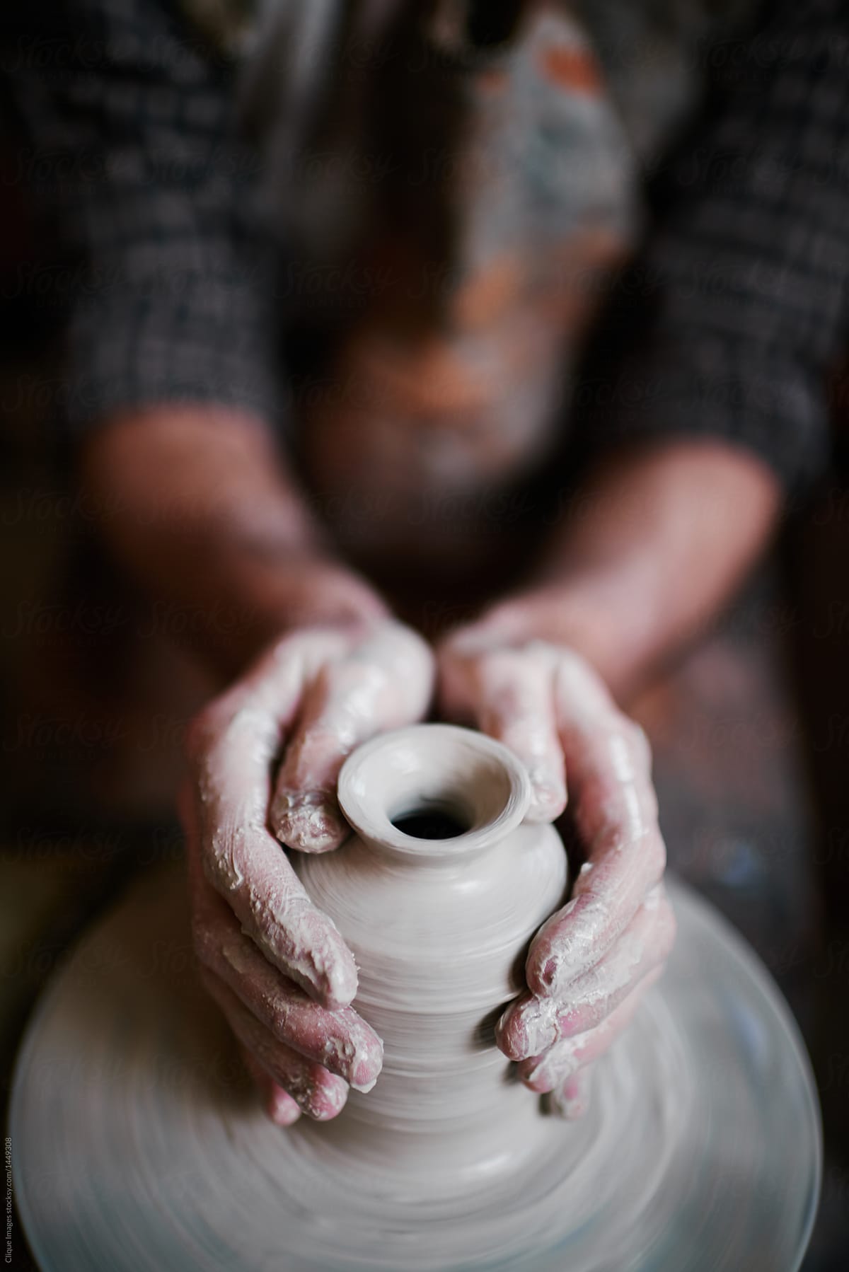 Talented  artisan working in pottery shop, making beautiful clay