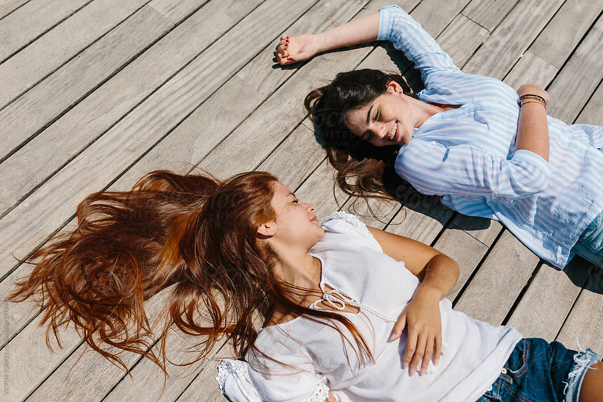 Teens Couple Sunbathing Of Wooden Floor By VICTOR T