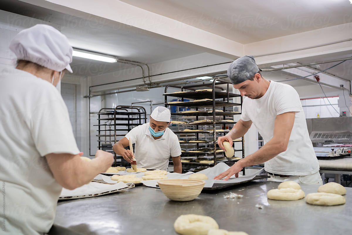 Team Of Colleagues Working In A Local Bread Factory.