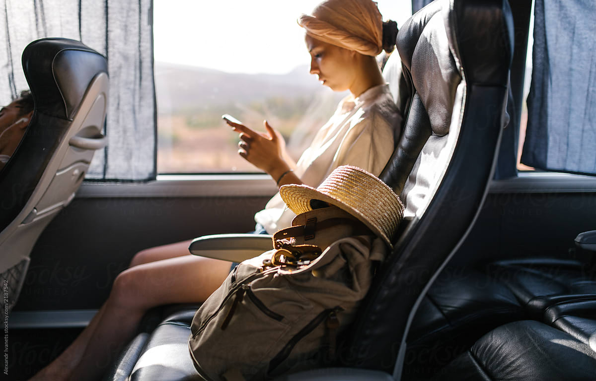 Modern woman with phone in bus