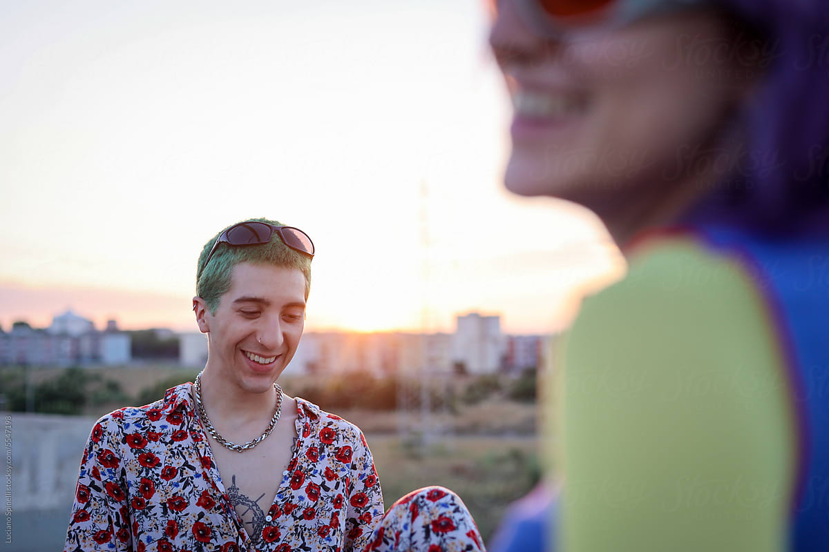 Golden hour colorful picture of alternative couple smiling
