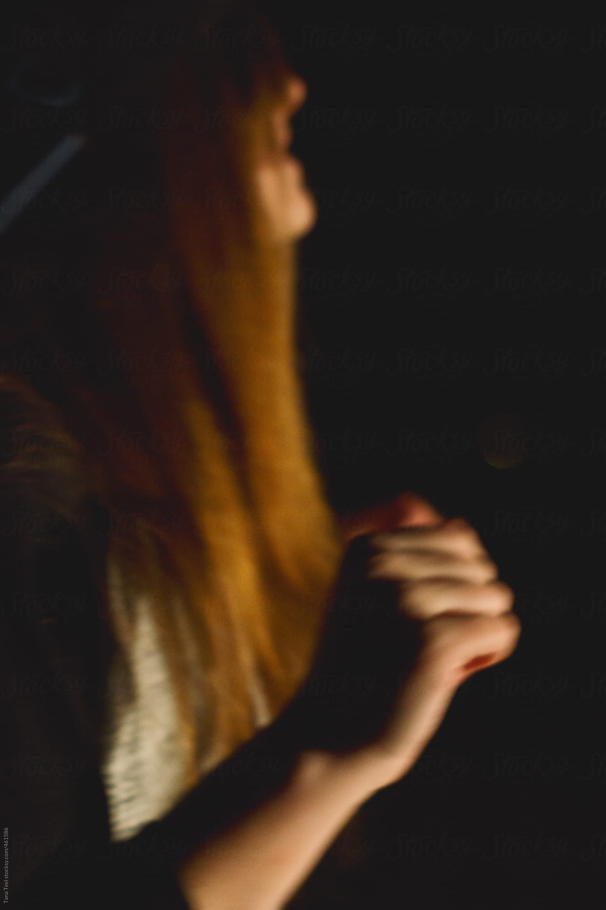 Blurred image of teenager dancing in the dark