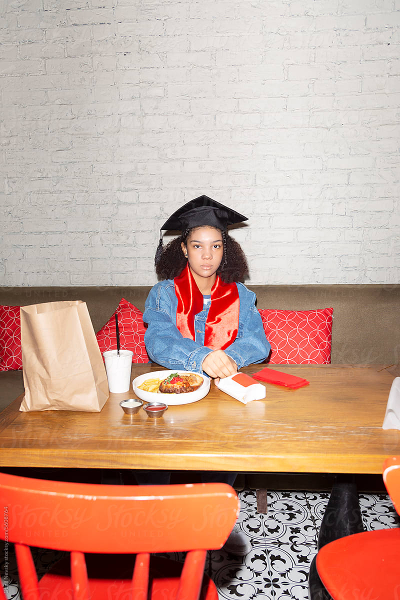Black female graduate student resting in restaurant