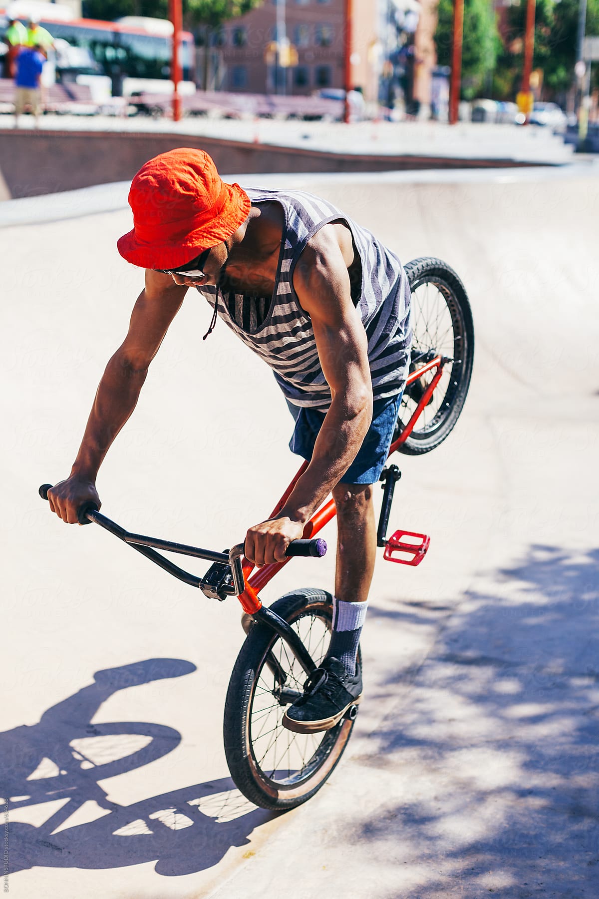 Young man jumping with BMX bike in a skate park.