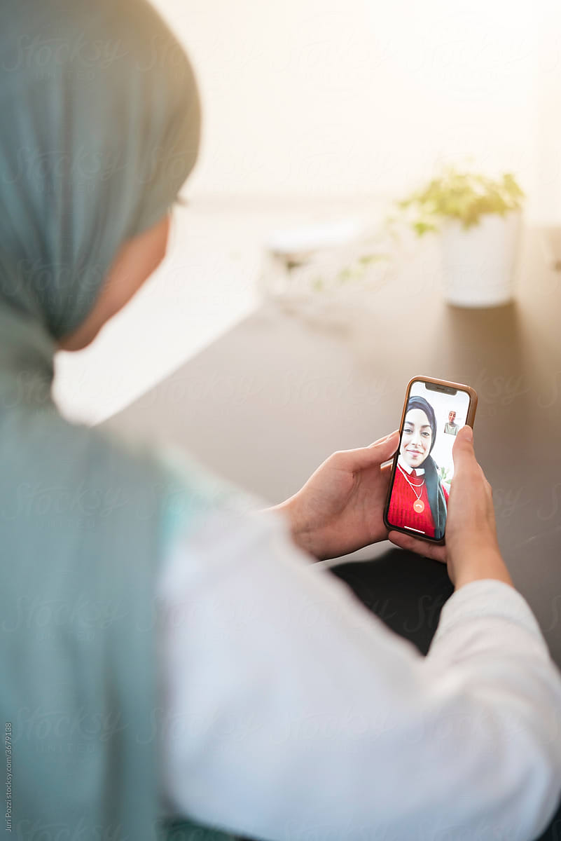 Muslim woman talking on video call via smartphone