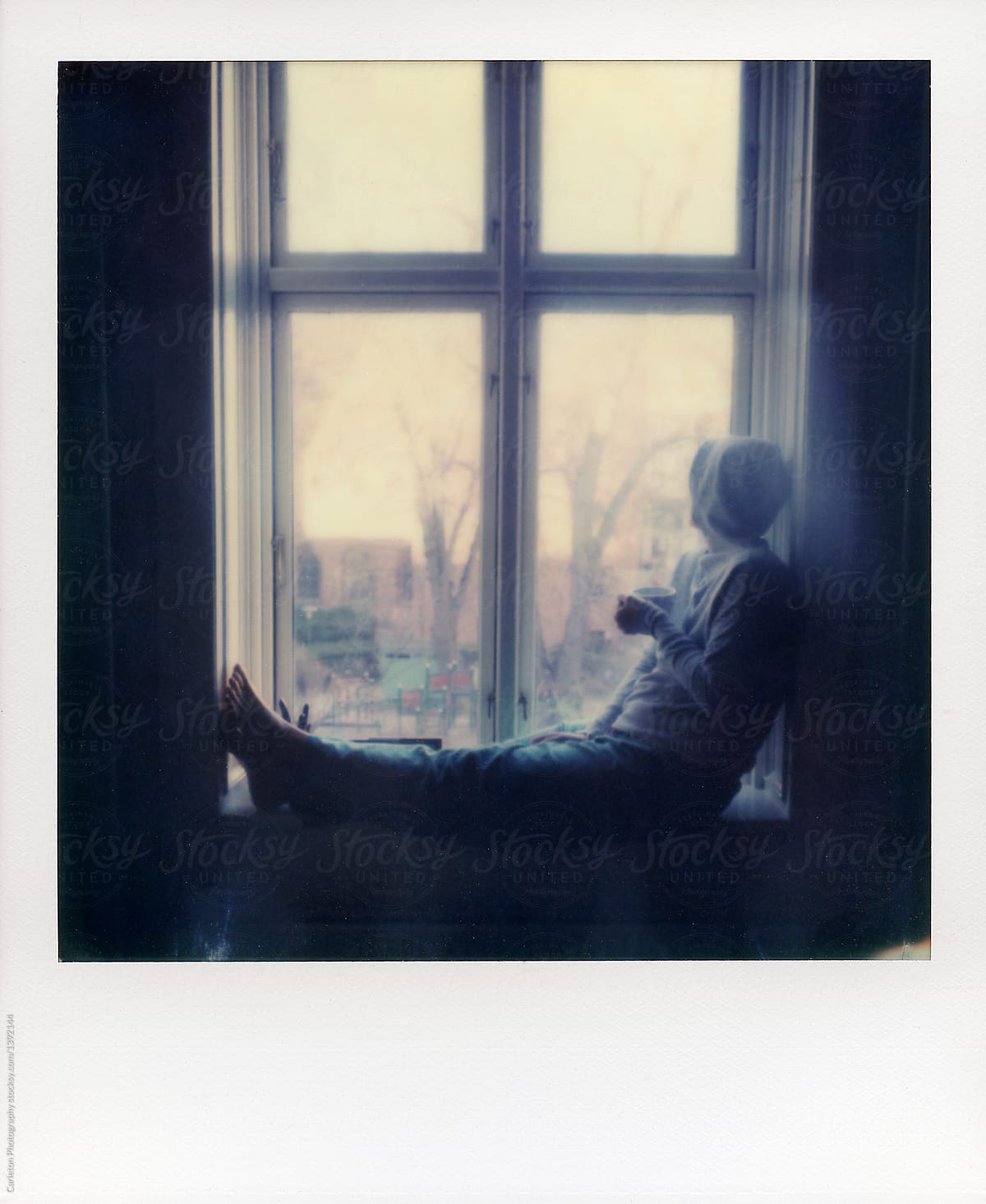 Woman relaxing with coffee on a windowsill
