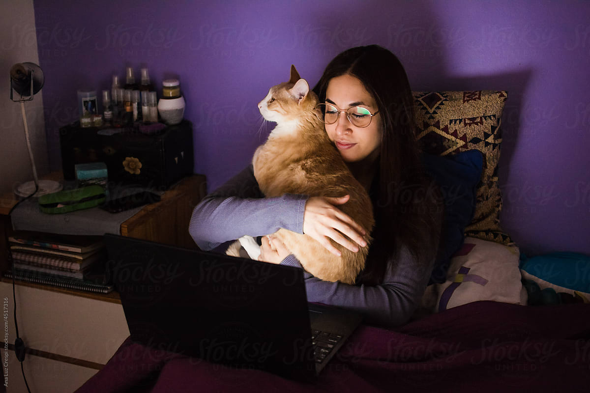 Latina woman and her cat stay in with streaming tv