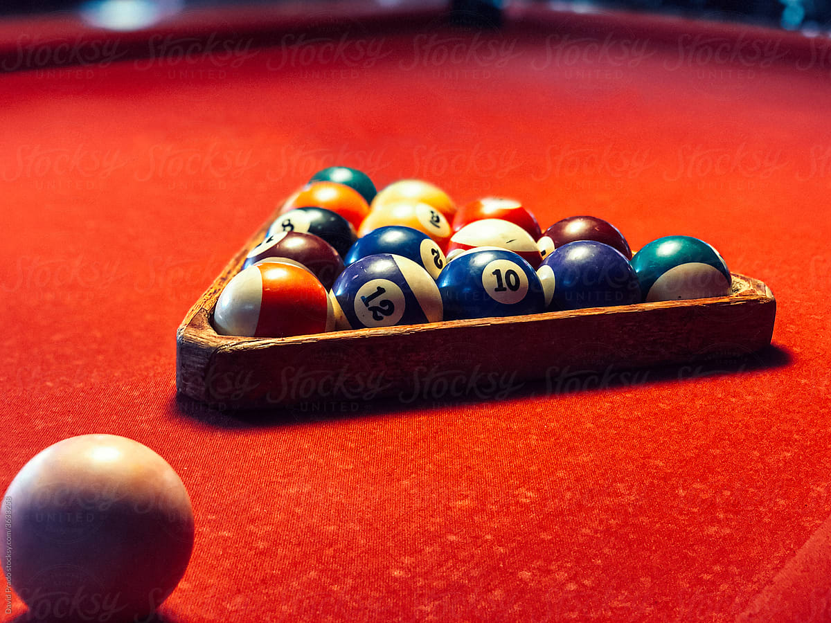 Billiards rack with balls on red billiards table