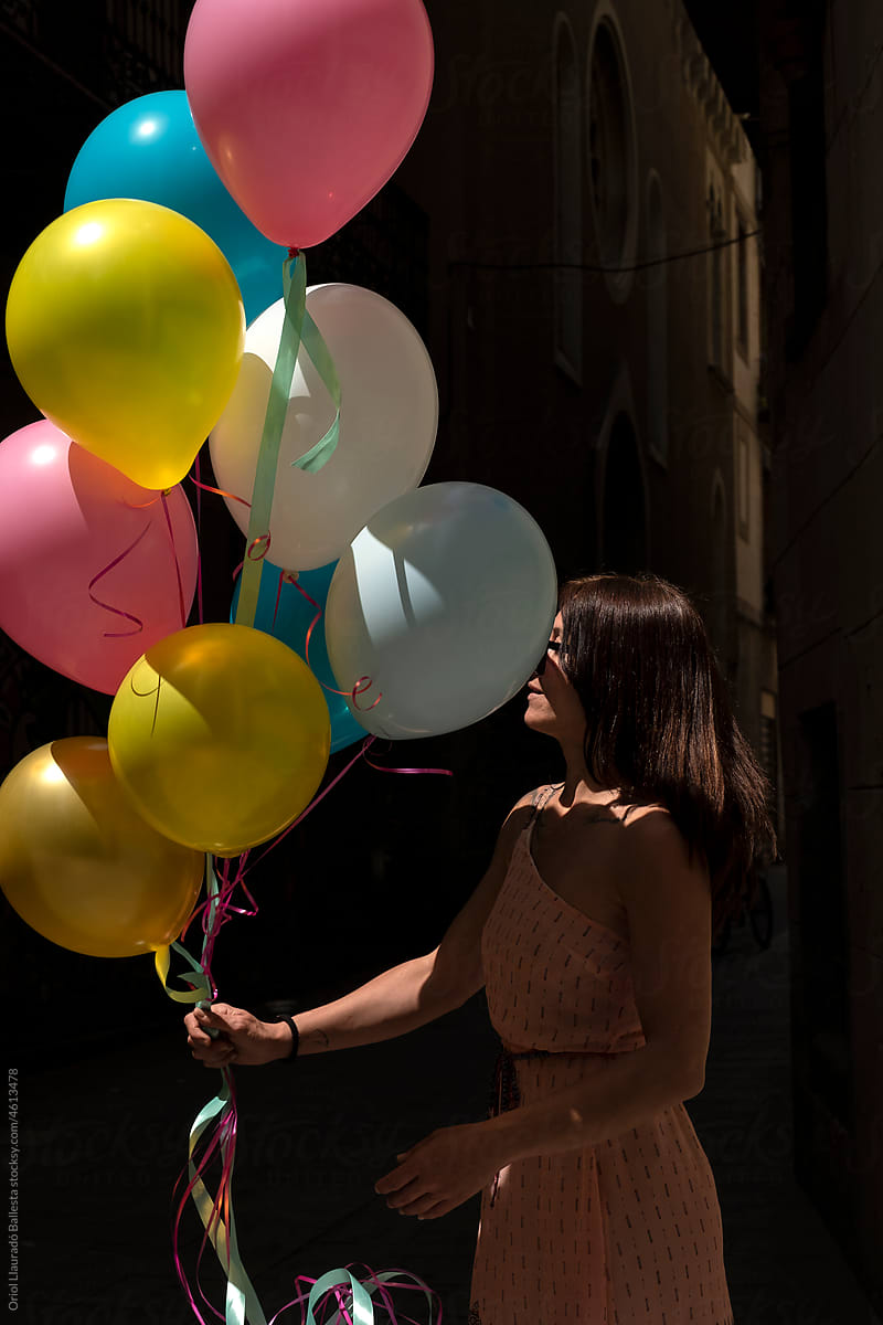 The beautiful woman with colored balloons