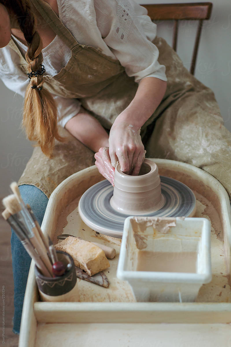 Woman using wheel for pottery
