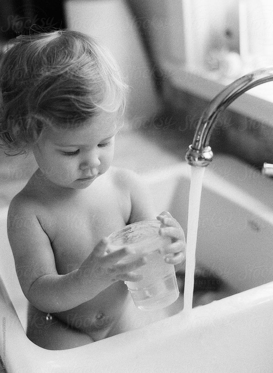 baby taking bath in sink