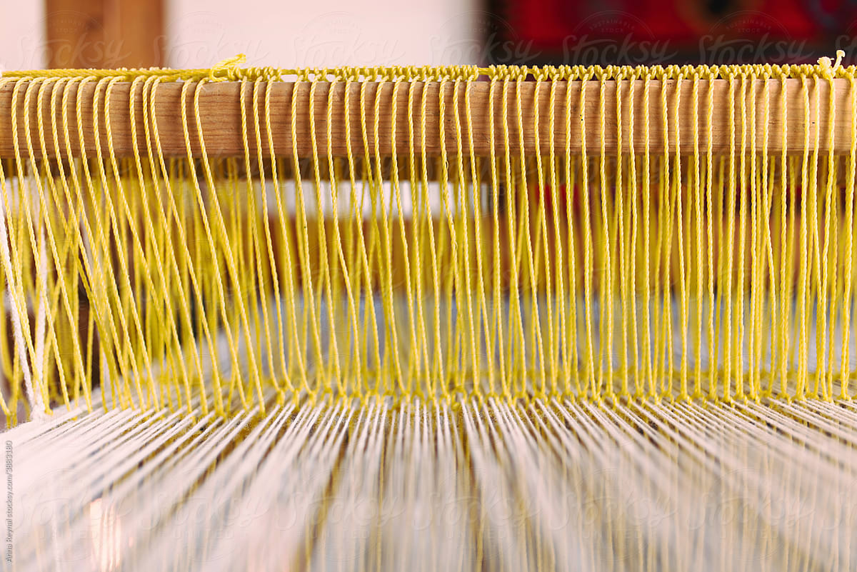 Yellow yarn on a loom