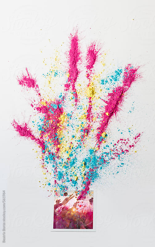 Photo taken at a festival on a white background with colorful holi powder all over it