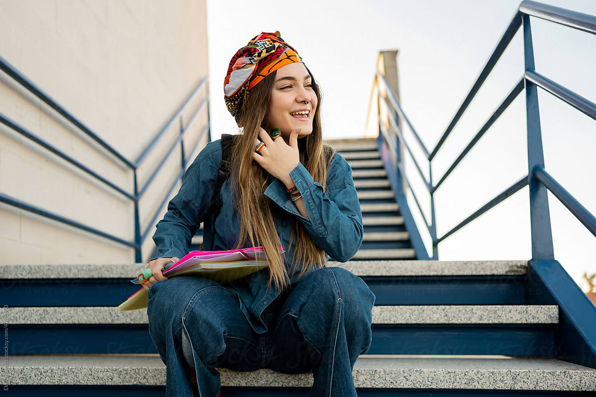 Smiling student girl outside on stairs