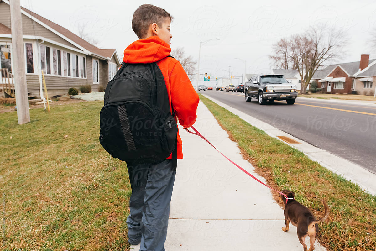 Boy walking home from school.