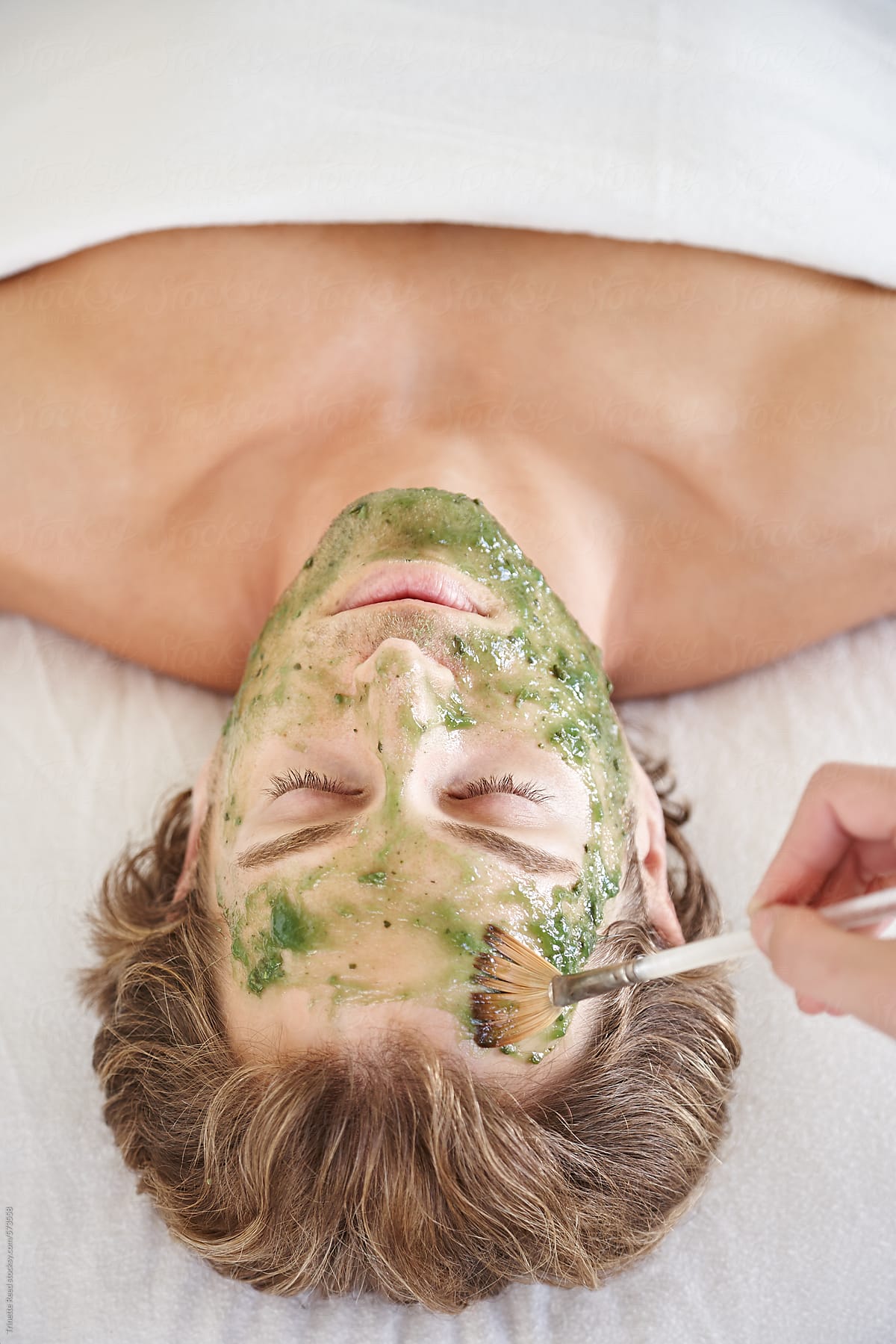 Man receiving all natural herbal facial at luxury spa