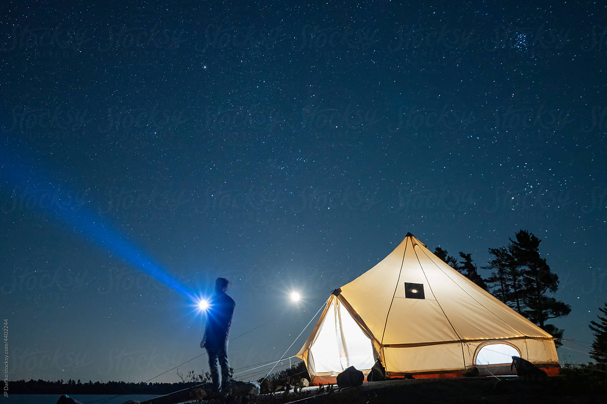 Man with Flashlight Night Sky on Wilderness Campsite