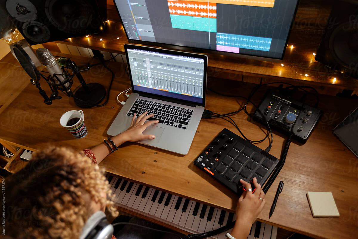 Music engineer working at home studio using midi pad controller