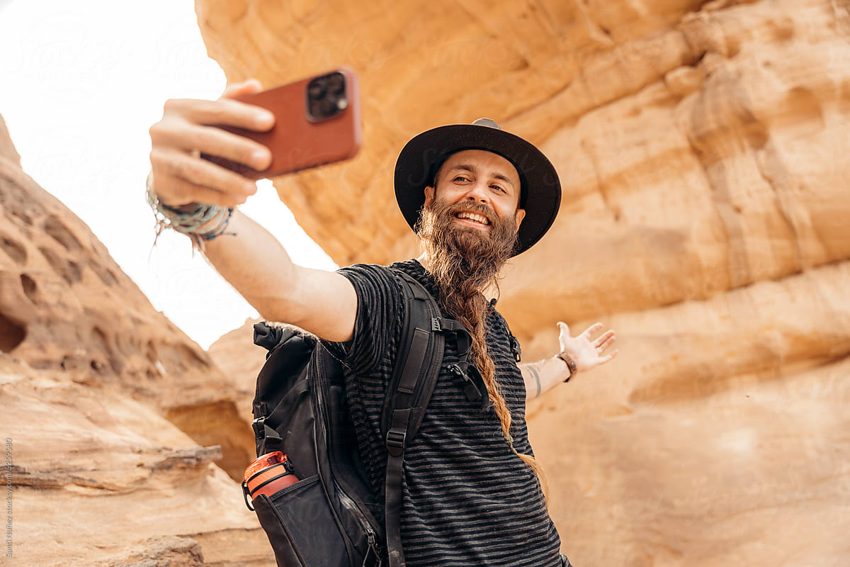 Traveler with beard using mobile phone