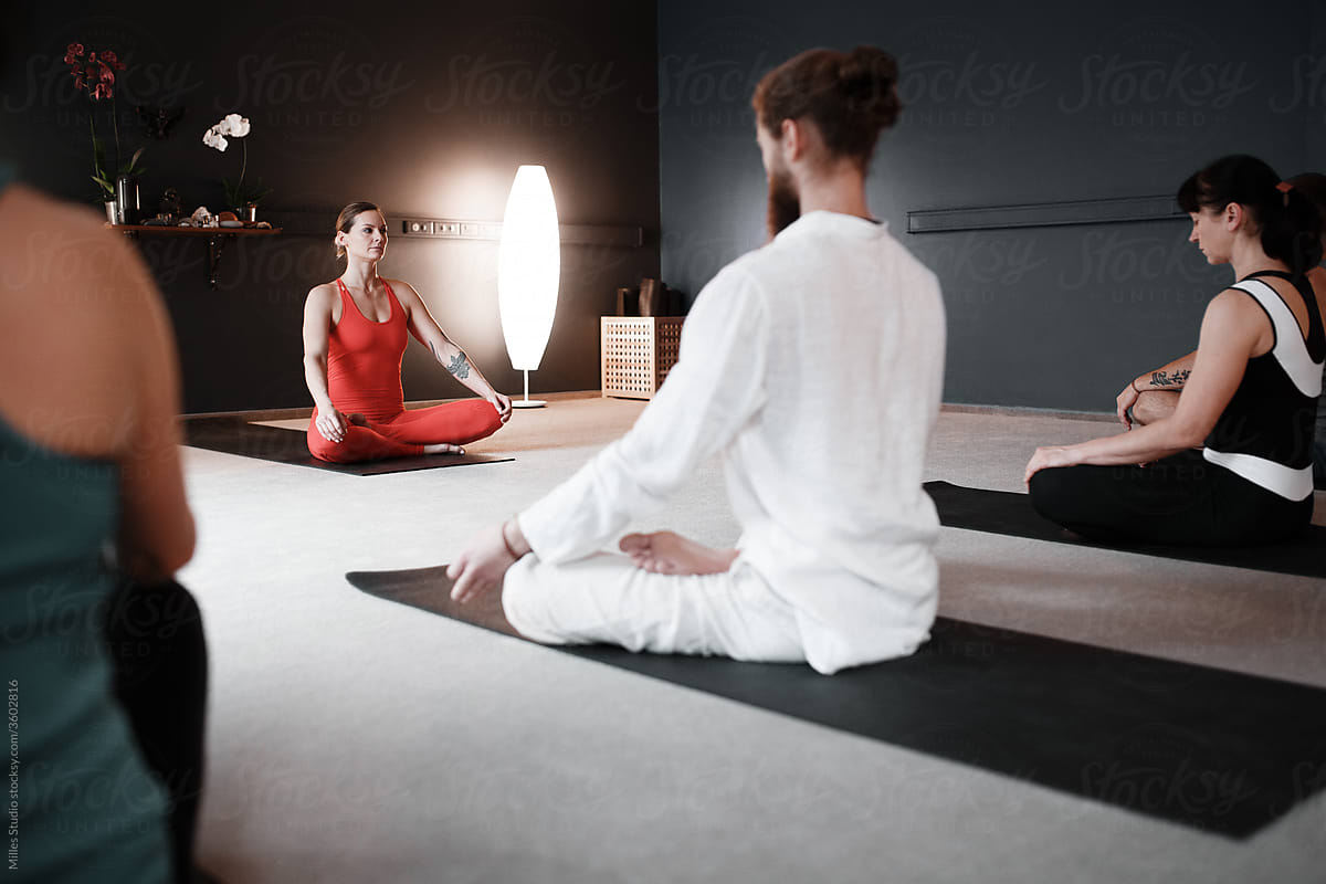 Female trainer showing meditation technique to group