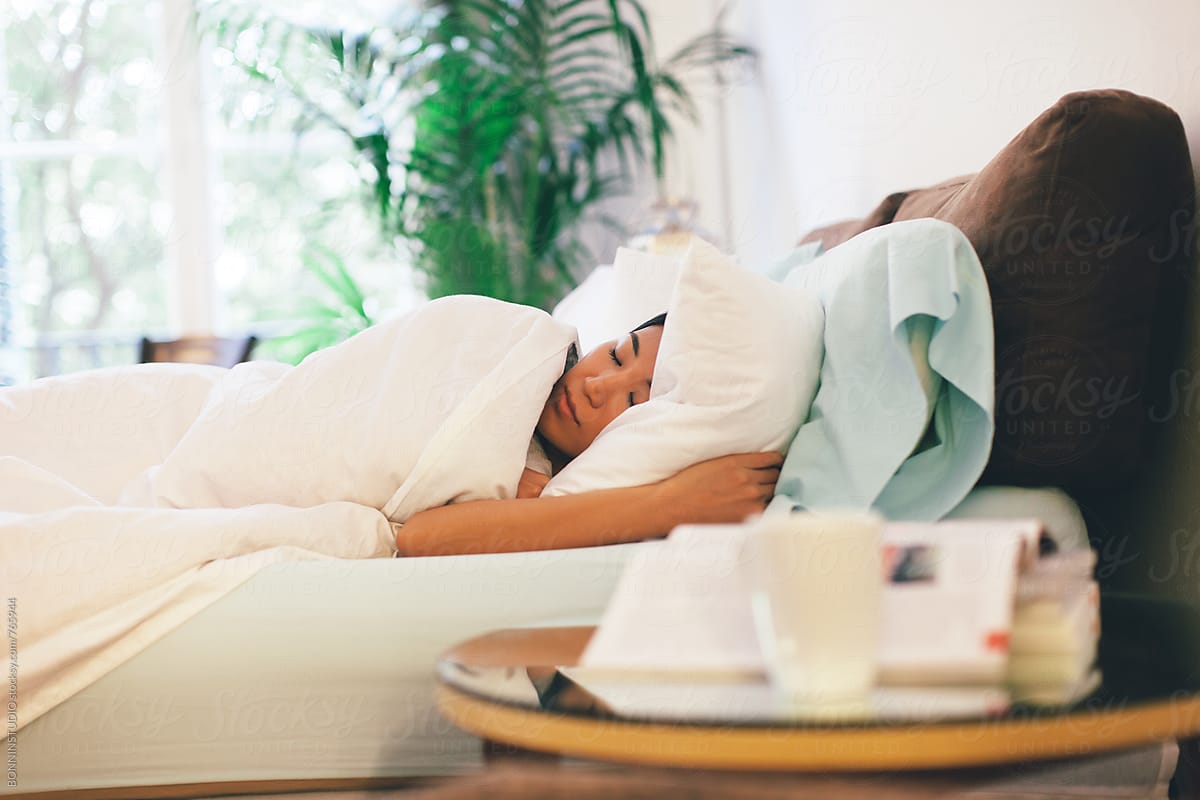 Side View Of A Young Asian Woman Sleeping In Bed By Stocksy