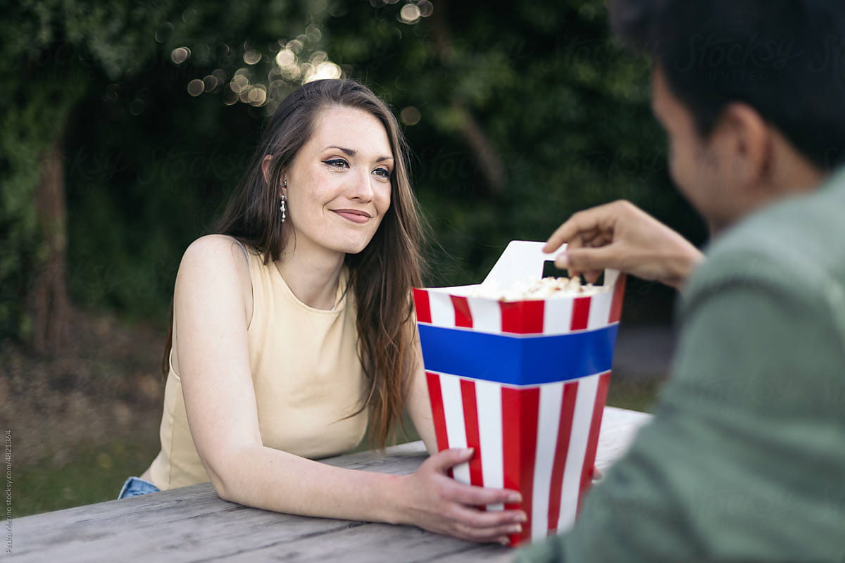 Couple sharing popcorn at the drive-in theater
