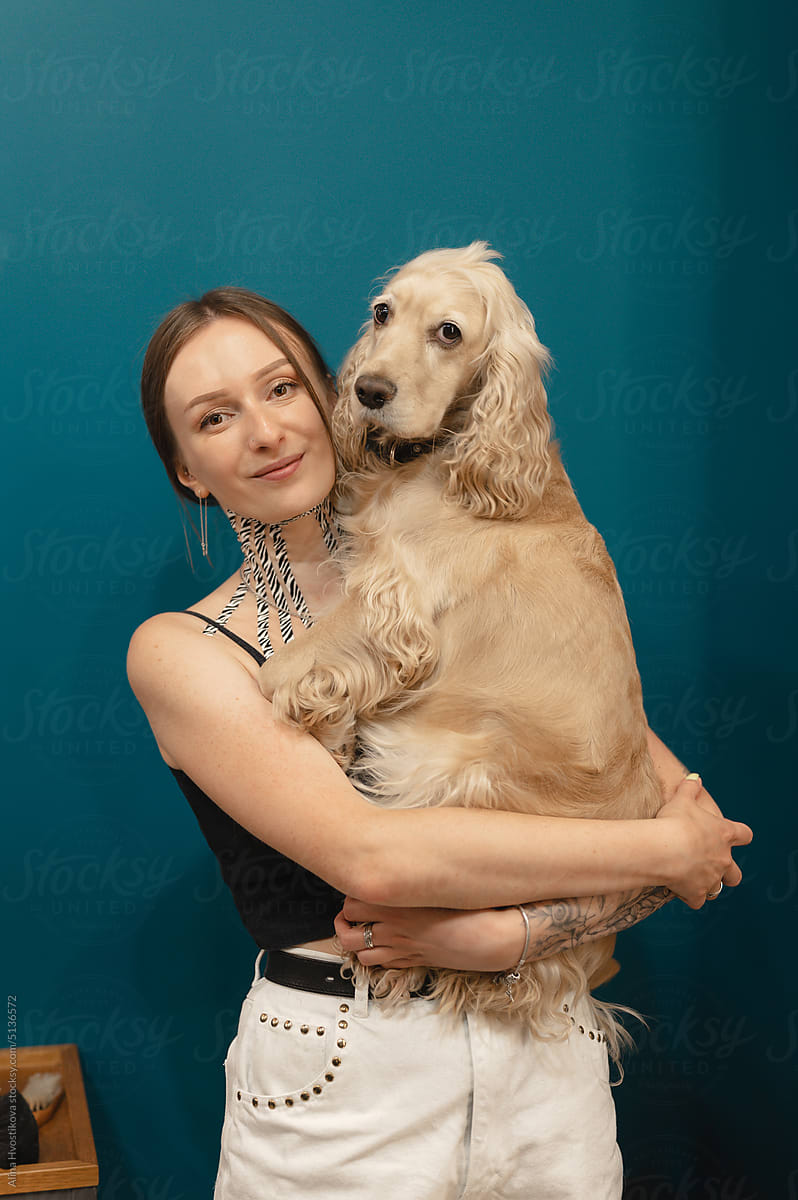 Smiling woman hugging cute dog