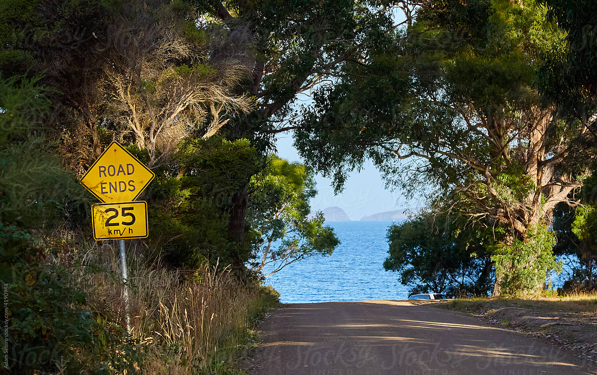 Road Ends sign - dirt terminates at ocean, Australia