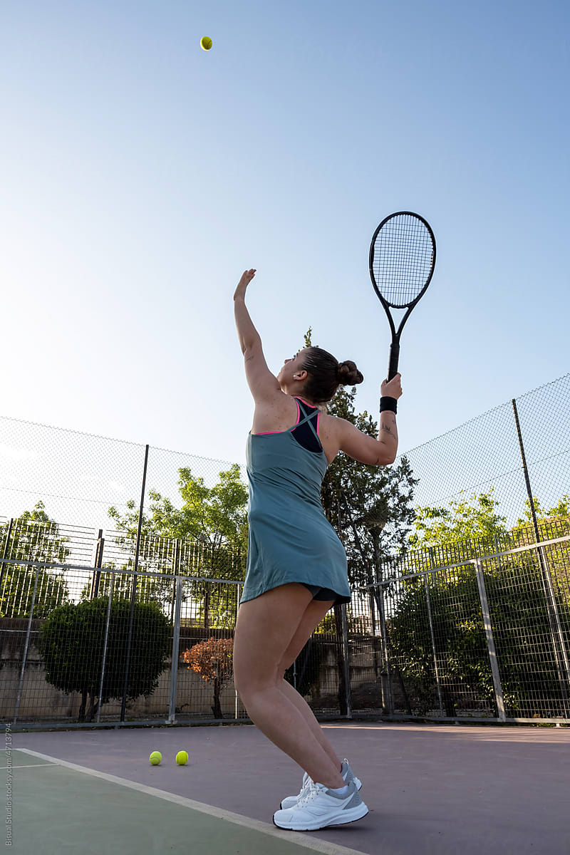 Female athlete playing tennis in morning