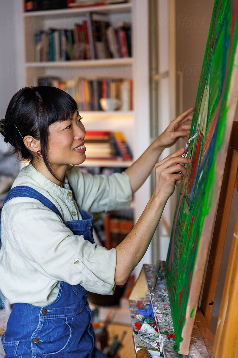 Smiling female artist painting