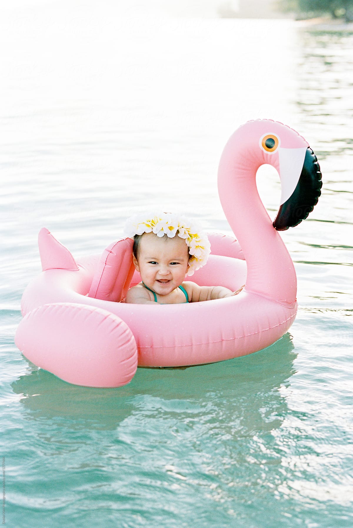 Portrait of smiling baby floating in ocean