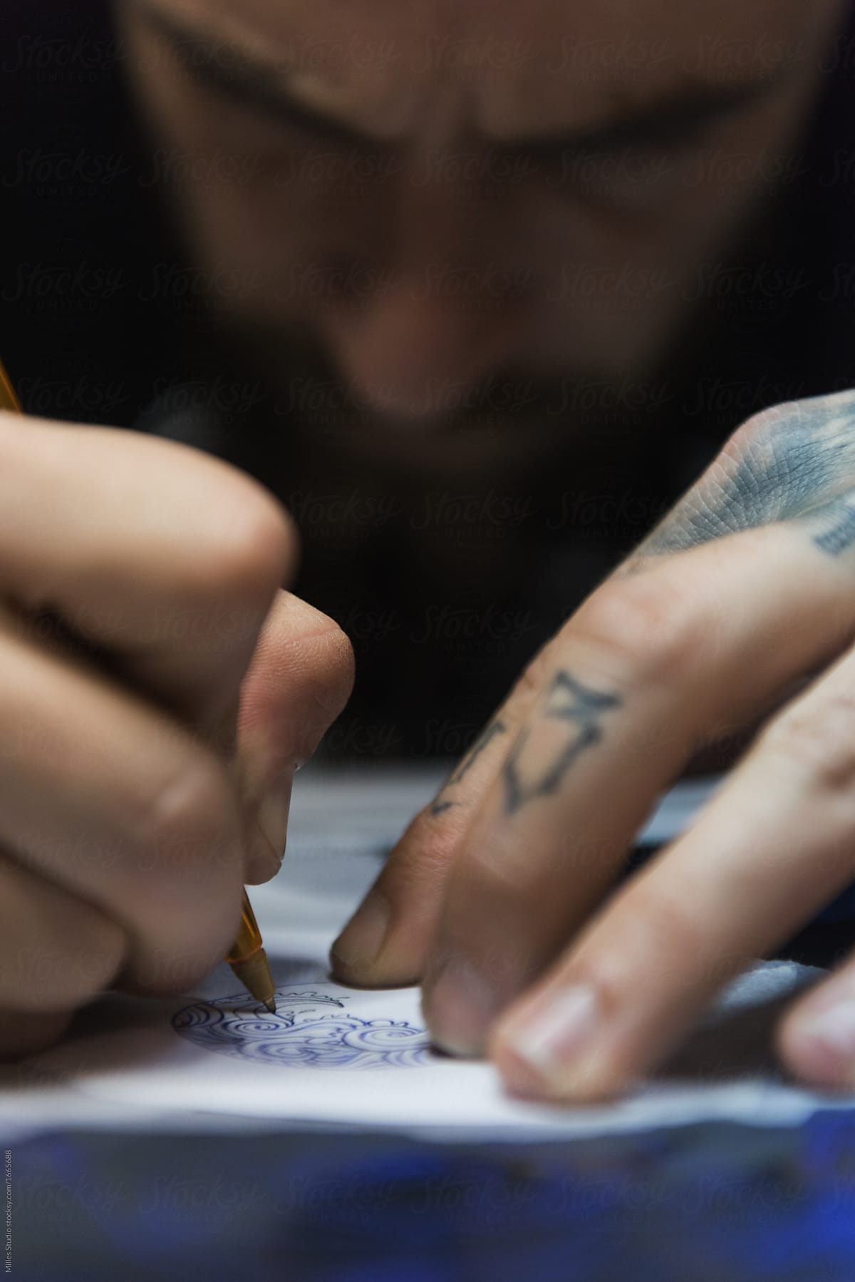 Close-up man drawing tattoo sketch