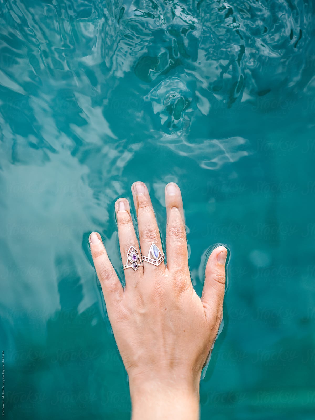 Crop hand in rings on water