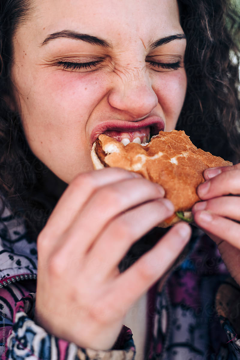 Teenager eating a hamburger