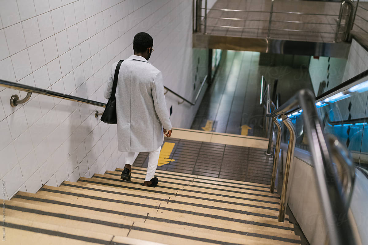 Man walking down stairs in subway station