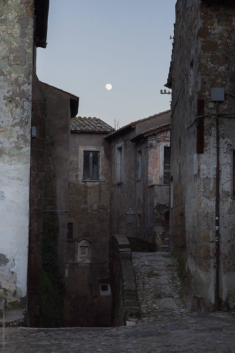 Moonrise in the old Italian city in winter