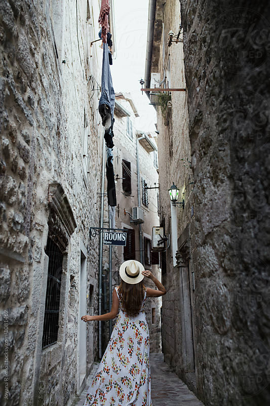 Young woman exploring an old town Kotor