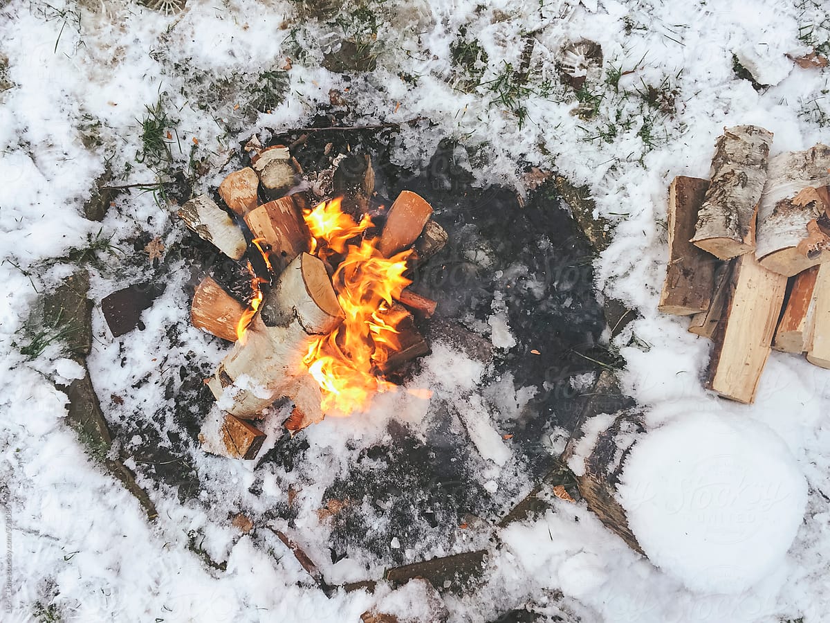 Small camp fire in the winter snow