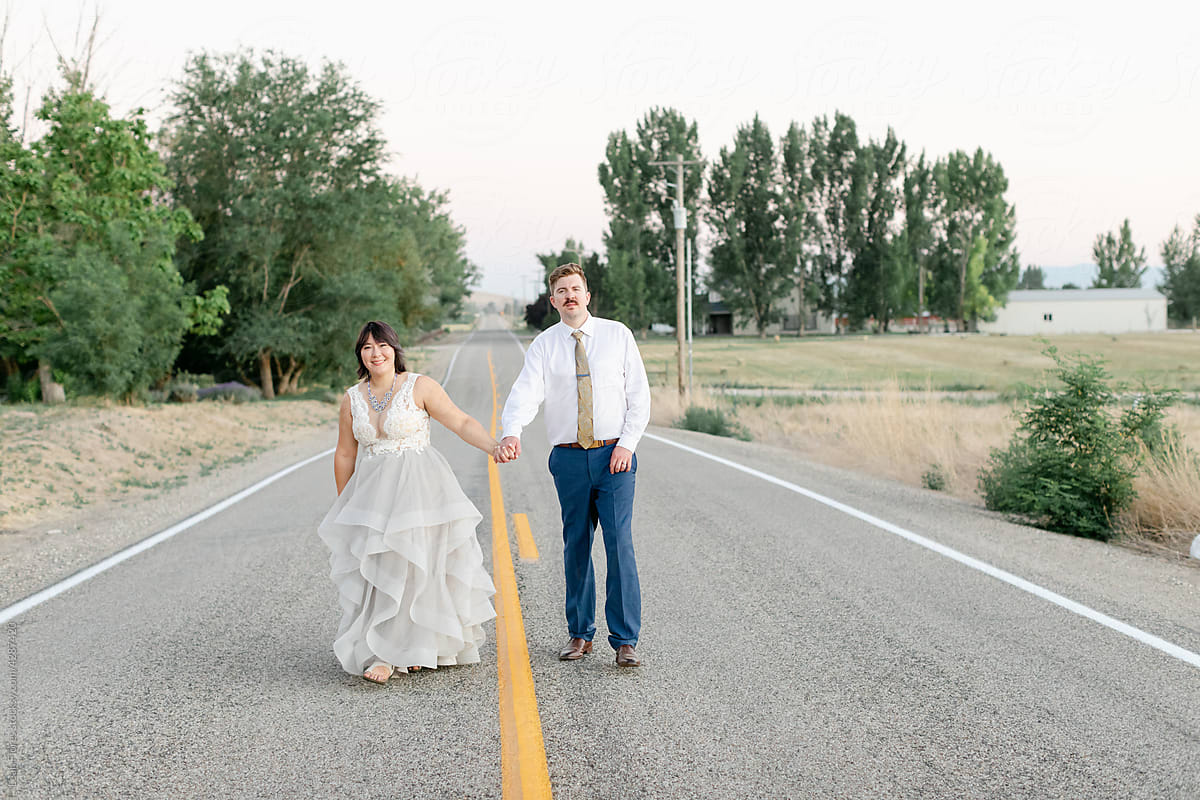 Bride and Groom Walking on Country Road