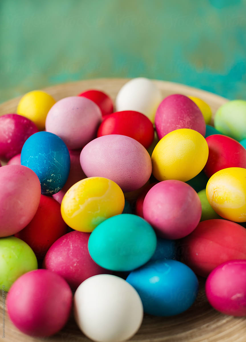 Multicolored Easter eggs on green background.
