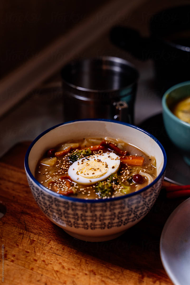 Bowl with noodles ramen and egg on counter
