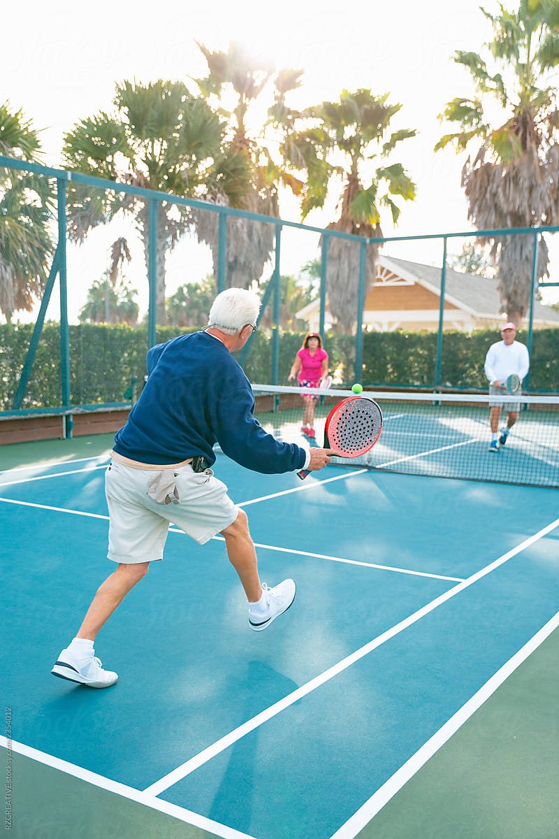 Active senior play tennis.